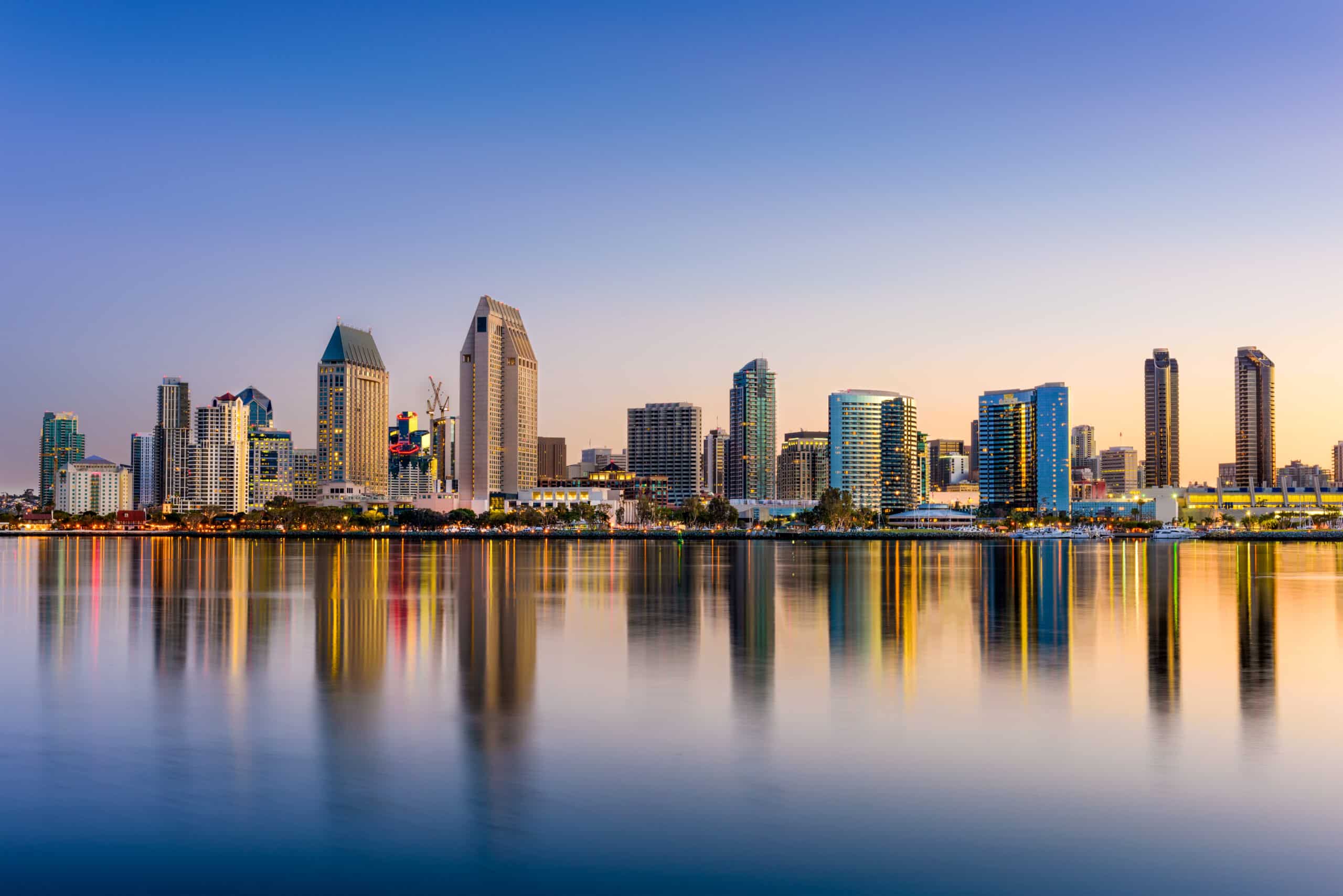 San Diego skyline at dusk, reflected in the water.
