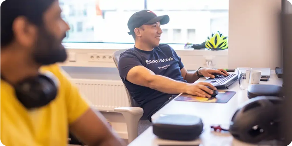 Office scene showing two colleagues working at their desks.