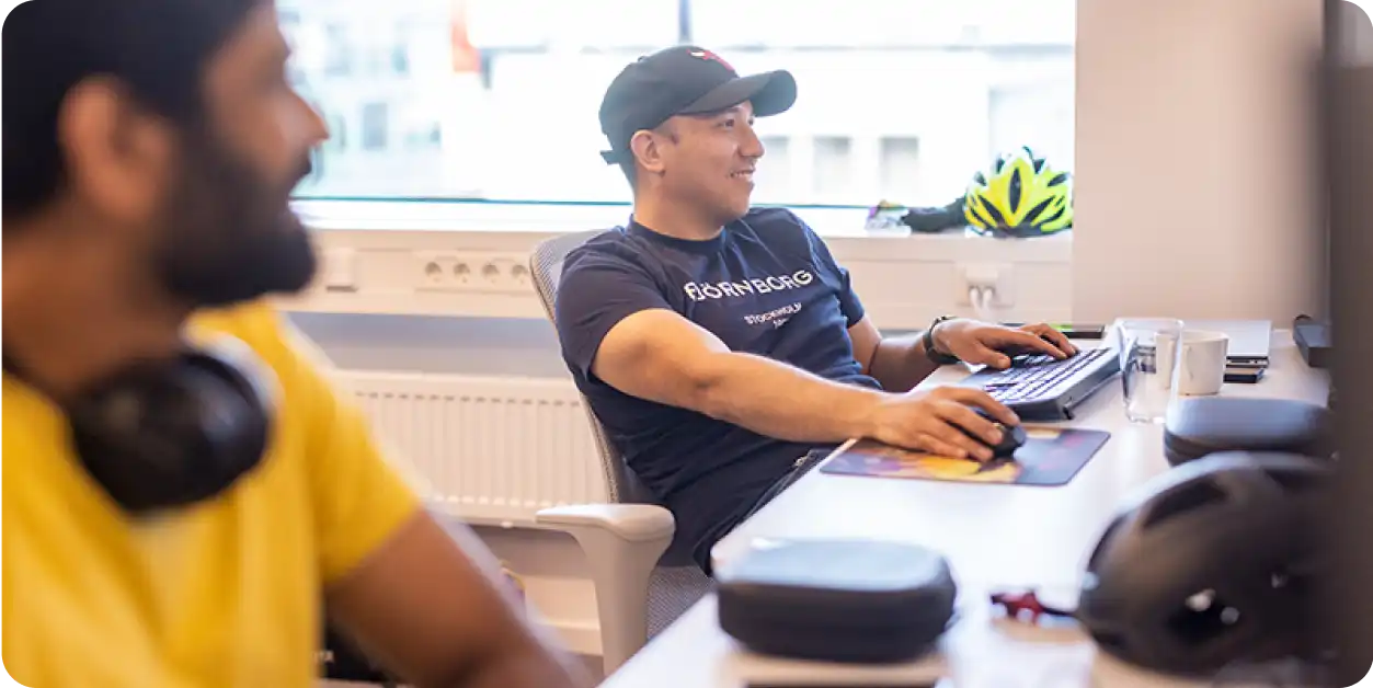 Office scene showing two colleagues working at their desks.