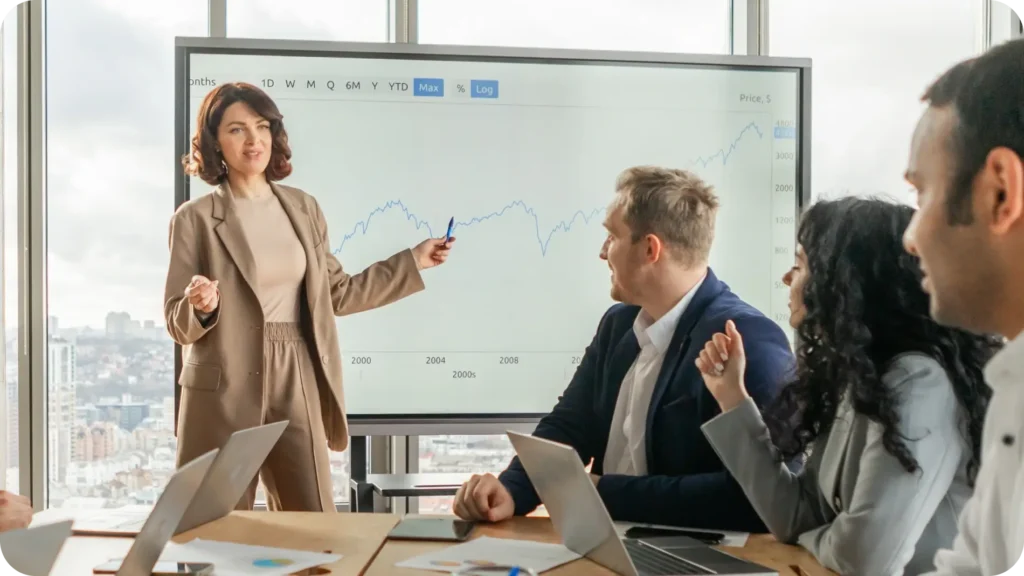 Business woman presenting in front of team.