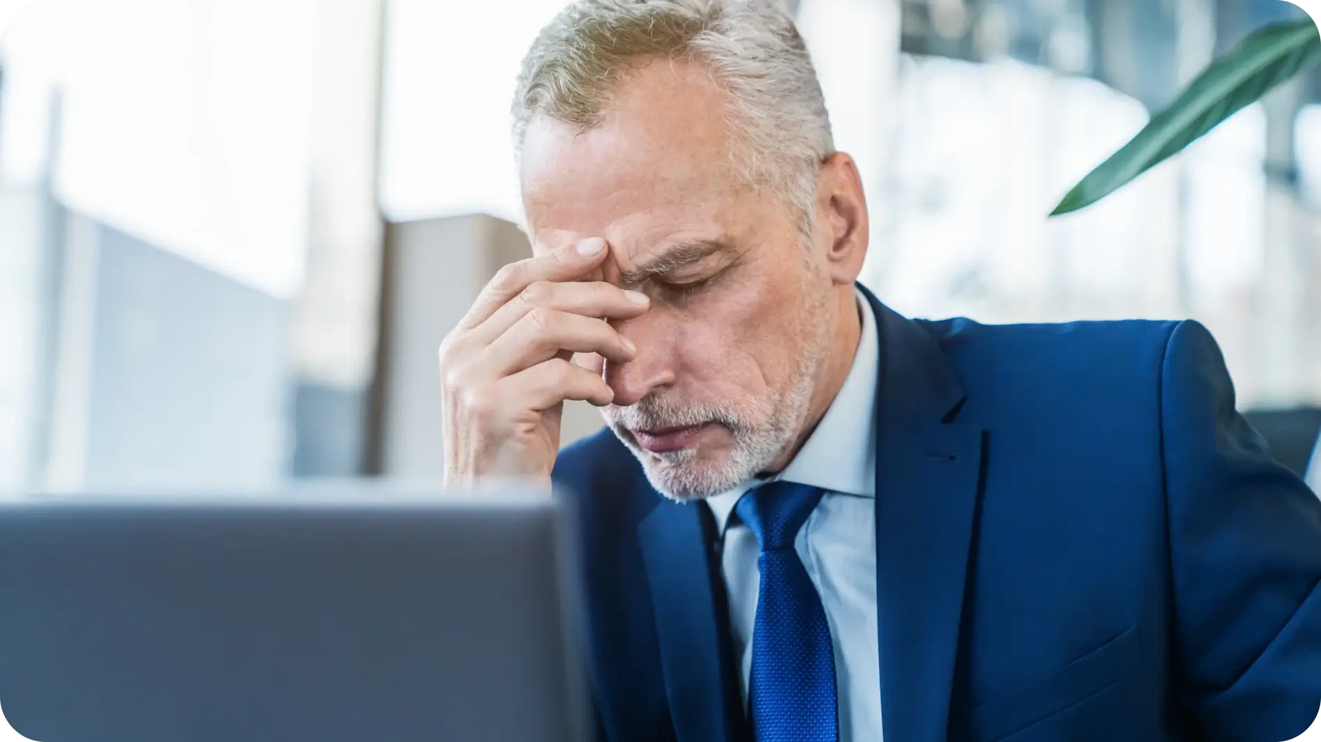 Frustrated business man in front of laptop.